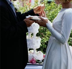 Bride and groom sharing wedding cake