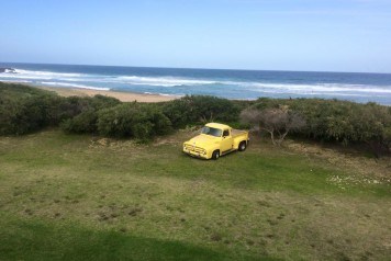 Yellow vintage pickup on beach